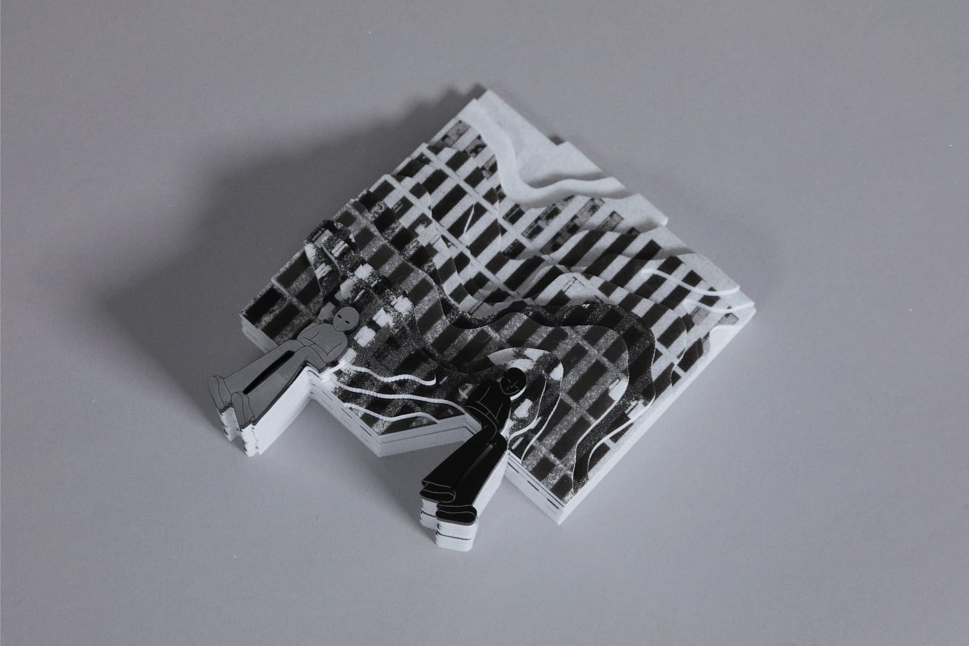 The secondary outcome of the cut-outs is glued together to show the layers in a more structured manner as a single artefact structure. 